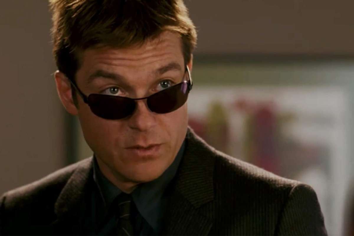 Jason Bateman peers out over a pair of sunglasses