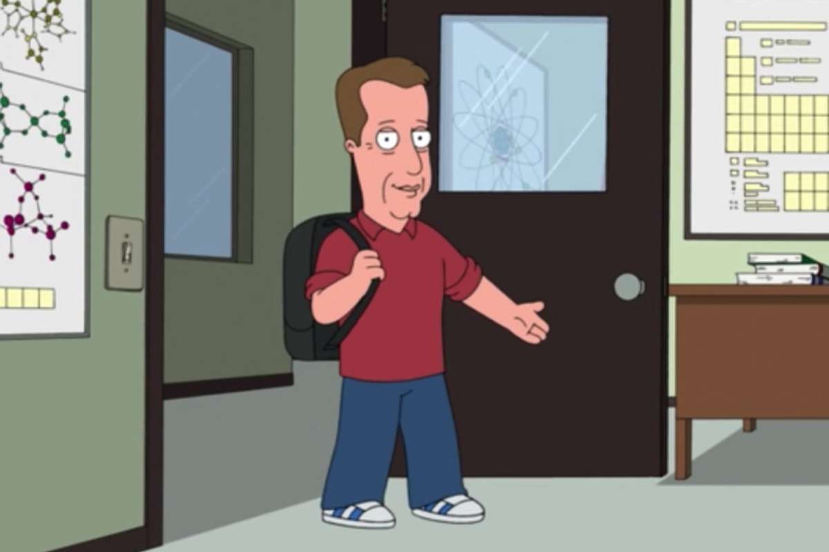 Woods wears a backpack and walks into a classrom