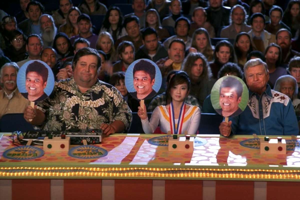 panel of judges holding up three Estrada scores